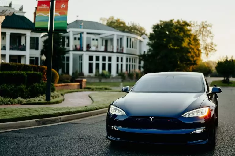 EV driving away from building