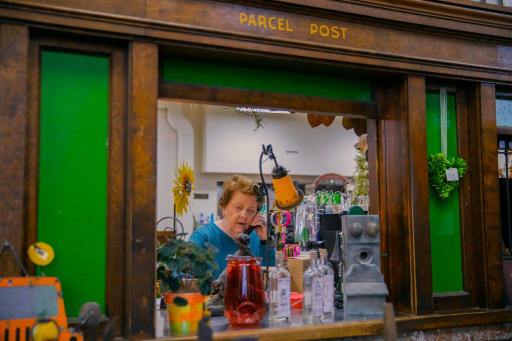 Woman answering phone in flower shop