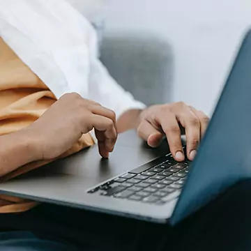 Close up of hands typing on laptop