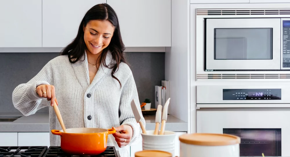Woman making soup in her kitchen.