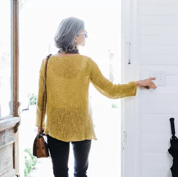 Woman turning the lights off as she leaves her home.
