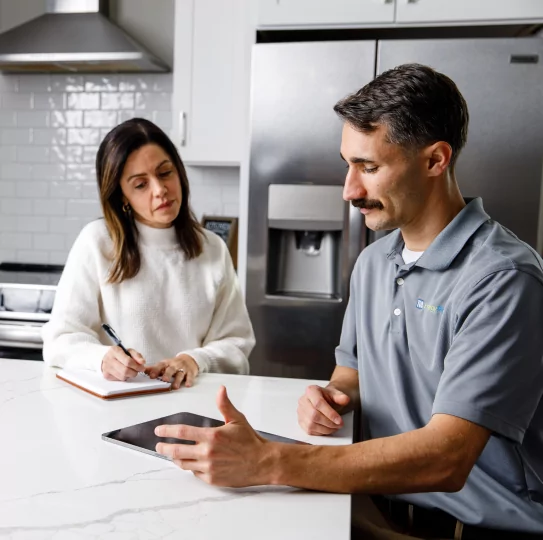 TVA EnergyRight Home Energy Advisor speaking to a woman in her kitchen.