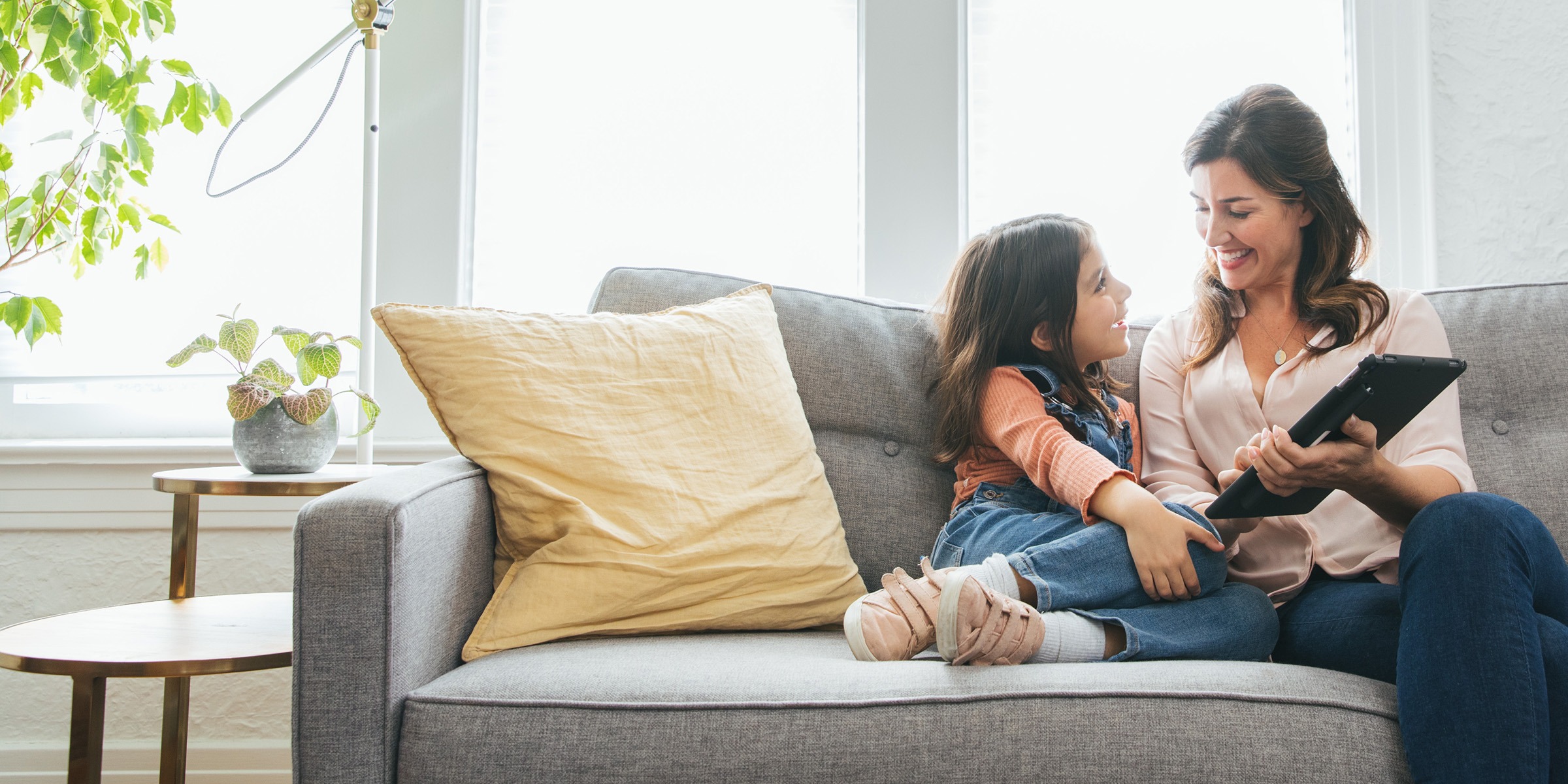 Mother and daughter on couch.