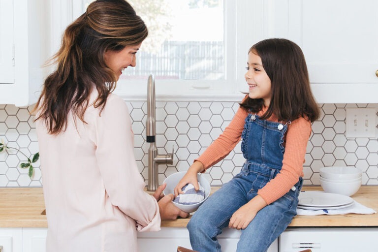 Mother and daughter in kitchen.
