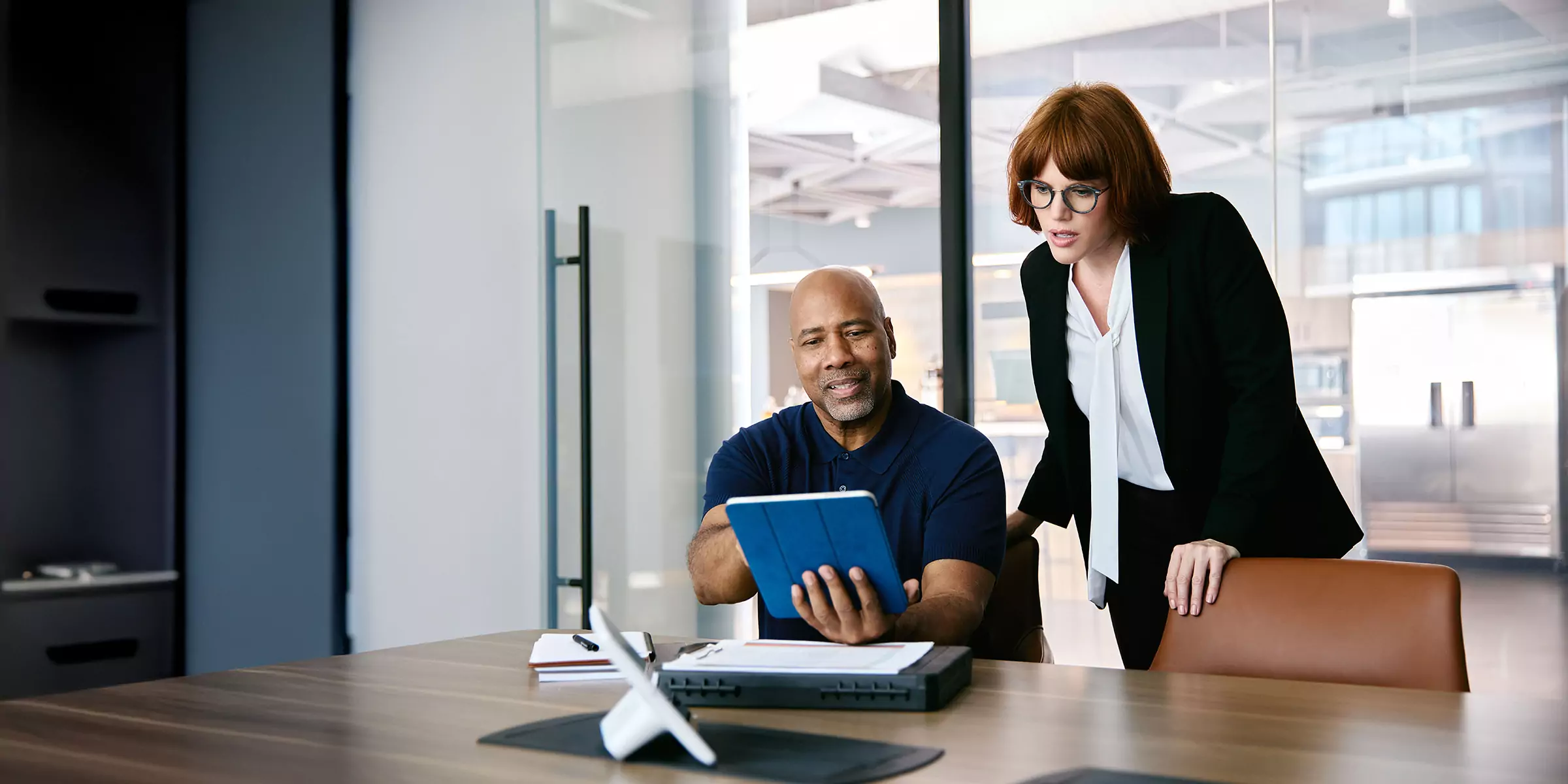 Man and woman talking in the office about energy efficiency tips
