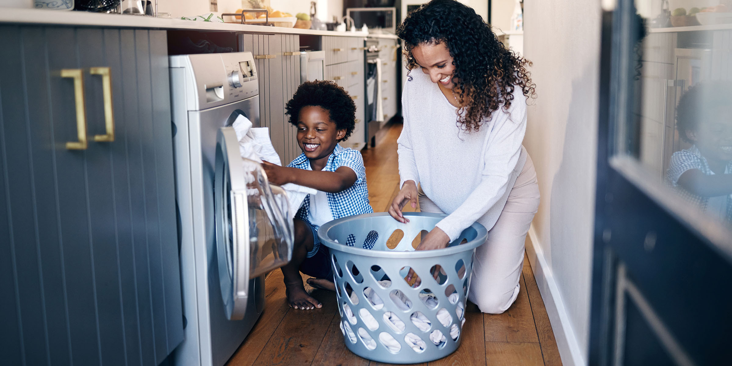 mother and son removing laundry from an energy efficient dryer.
