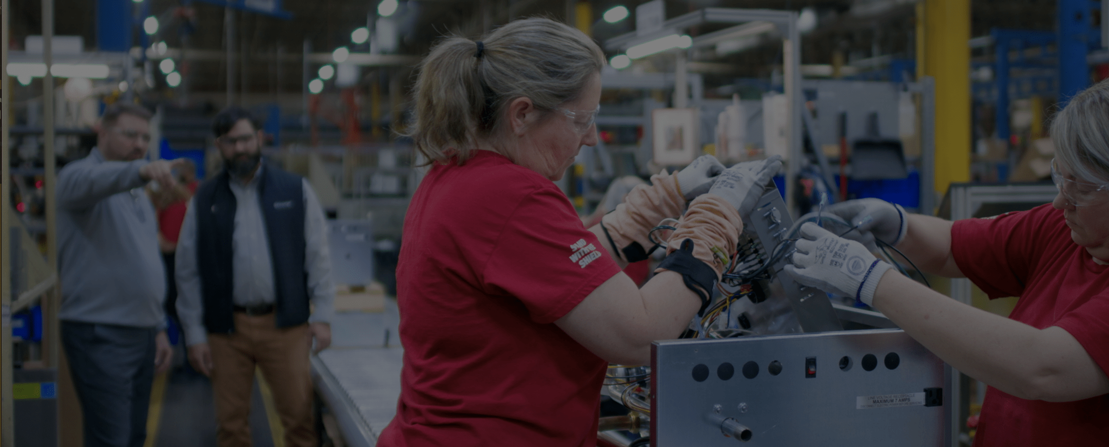 Woman working on an assembly line.