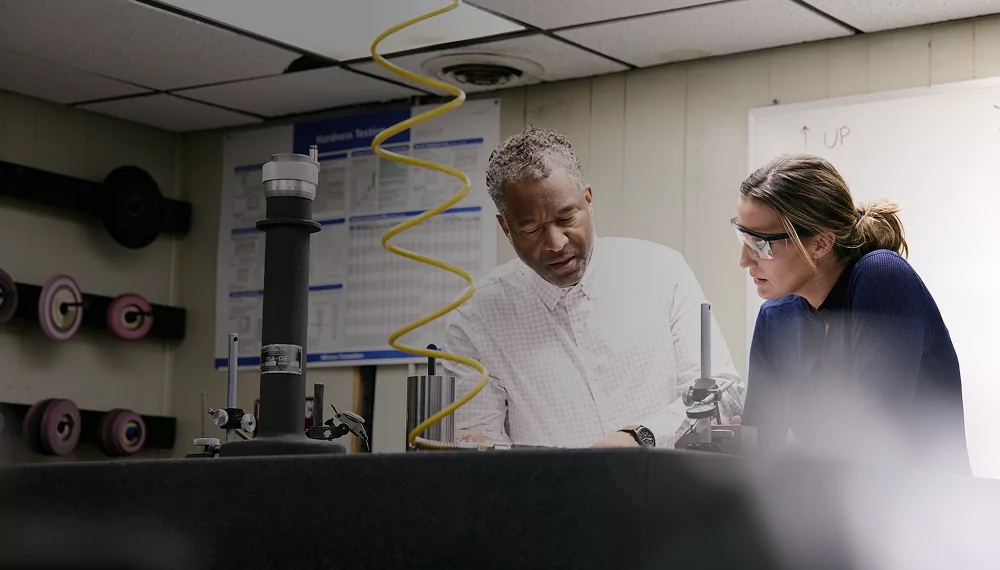 Header image of two people talking in a workshop with compressed air systems
