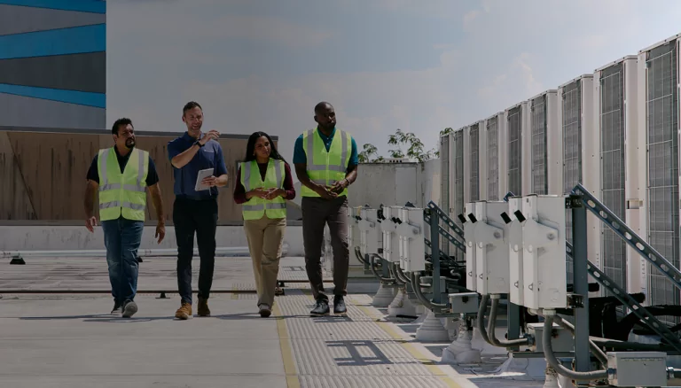 A TVA Energy Advisor and worker on a rooftop