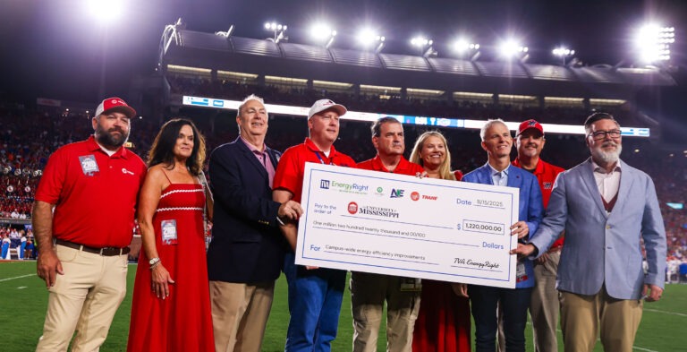 Ole Miss staff accepts energy upgrade check.