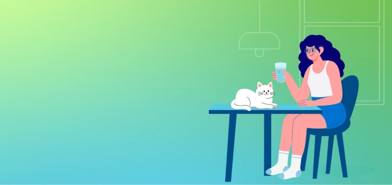 A woman with glasses sits at a kitchen table drinking a glass of water while a white cat rests nearby against a green and blue gradient background.