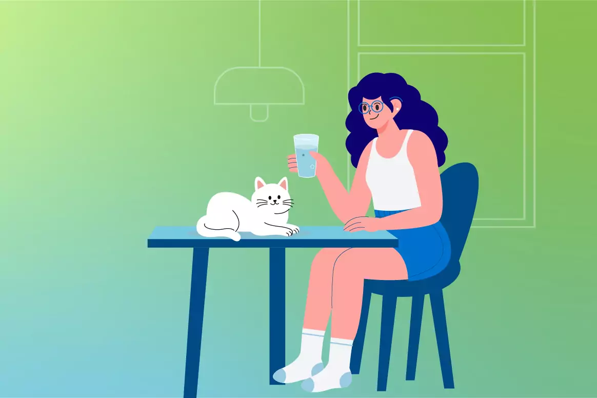 A woman with glasses sits at a kitchen table drinking a glass of water while a white cat rests nearby against a green and blue gradient background.