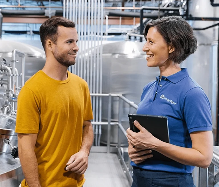 A TVA Energy Expert helps a business owner in an industrial facility find energy efficiency solutions.