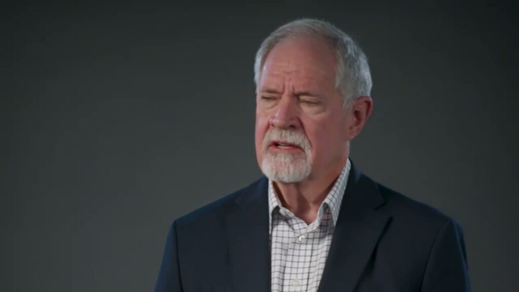 A TVA Energy Expert, an older man with a gray beard in a suit, speaks about energy-efficient home solutions.
